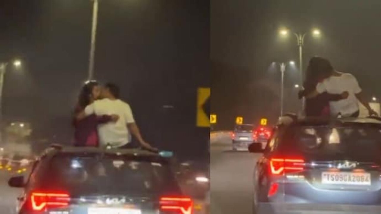 Video of a couple kissing over a car's sunroof while driving on ...